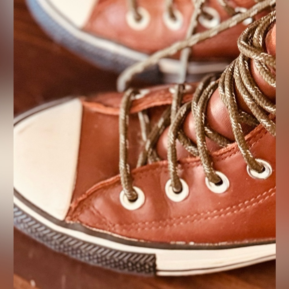 Woman’s Converse brown leather, high top sneakers .